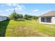 Expansive backyard with well-maintained lawn, stone perimeter fence, and privacy trees at 3753 Apopka Ridge Cir, Apopka, FL 32703