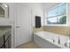 Bathroom featuring granite countertops, a soaking tub, ceramic tile details, and a window with blinds at 3753 Apopka Ridge Cir, Apopka, FL 32703