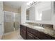 Bathroom featuring double sinks with granite countertops, a glass door shower, and tile floors at 3753 Apopka Ridge Cir, Apopka, FL 32703