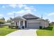Single-story home features a well-maintained lawn, a two-car garage, and a light gray color scheme at 3753 Apopka Ridge Cir, Apopka, FL 32703