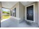 Covered front porch with black front door and black shuttered windows, providing a welcoming entrance at 3753 Apopka Ridge Cir, Apopka, FL 32703