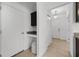 Hallway with tiled floors, white walls, and granite countertop, which has base cabinet space at 3753 Apopka Ridge Cir, Apopka, FL 32703