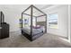 Primary bedroom with a bed frame and view to the backyard through sliding glass doors at 3753 Apopka Ridge Cir, Apopka, FL 32703