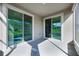 Rear covered patio with dual sliding glass doors and painted concrete floors at 3753 Apopka Ridge Cir, Apopka, FL 32703