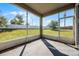 View from the screened in porch of the expansive backyard with well-maintained lawn and perimeter fencing at 3753 Apopka Ridge Cir, Apopka, FL 32703
