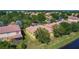 Aerial view showcases the property's lake view and manicured landscaping at 3908 Coastal Breeze Dr, Kissimmee, FL 34744