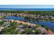Community aerial showcasing waterfront property, manicured lawns, and community landscaping at 3908 Coastal Breeze Dr, Kissimmee, FL 34744