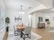 Bright dining room with modern table set, chandelier, and seamless flow to the living area at 3908 Coastal Breeze Dr, Kissimmee, FL 34744
