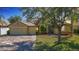 Inviting single-story home with a well-manicured lawn, brick driveway, and a two-car garage at 3908 Coastal Breeze Dr, Kissimmee, FL 34744
