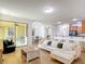 Open concept living room featuring tile floors, neutral colors, and a breakfast bar at 3908 Coastal Breeze Dr, Kissimmee, FL 34744