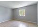 Bright bedroom featuring neutral paint and a window view for a peaceful retreat at 4117 S Semoran Blvd # 17, Orlando, FL 32822