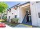 Two-story exterior view of condo building with stairs leading to upper units at 4117 S Semoran Blvd # 17, Orlando, FL 32822