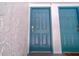 Close-up view of teal-colored doors with gold numbering on textured stucco wall at 4117 S Semoran Blvd # 17, Orlando, FL 32822