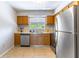 Functional kitchen with stainless steel appliances, light wood cabinets, and a garden view at 4117 S Semoran Blvd # 17, Orlando, FL 32822