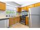 Well-lit kitchen featuring stainless steel appliances and ample counter space at 4117 S Semoran Blvd # 17, Orlando, FL 32822