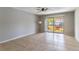 Bright, open living room with tiled flooring and sliding glass doors to a patio at 4117 S Semoran Blvd # 17, Orlando, FL 32822