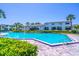 Community swimming pool with nearby condo buildings and landscaping in a sunny and inviting setting at 4117 S Semoran Blvd # 17, Orlando, FL 32822