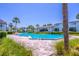Bright swimming pool for community residents with palms and paver deck in a condo community on a sunny day at 4117 S Semoran Blvd # 17, Orlando, FL 32822