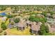 Elevated view of the complex showcasing the surrounding greenery and pond in the distance at 420 Summit Ridge Pl # 112, Longwood, FL 32779