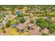Aerial view of an apartment complex by a water feature, showcasing the well-manicured landscaping and serene environment at 420 Summit Ridge Pl # 112, Longwood, FL 32779