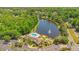 Wide angle overhead shot of the community pool and clubhouse with water feature and manicured landscaping at 420 Summit Ridge Pl # 112, Longwood, FL 32779