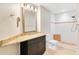 Bathroom featuring a granite-topped vanity with sink, framed mirror, recessed lighting, and a tiled shower at 420 Summit Ridge Pl # 112, Longwood, FL 32779