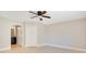 Bright bedroom featuring neutral walls, a ceiling fan, and a door to bathroom at 420 Summit Ridge Pl # 112, Longwood, FL 32779