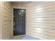 Front door of condo with exterior siding and electronic entry at 420 Summit Ridge Pl # 112, Longwood, FL 32779