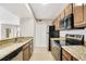 Kitchen boasts granite countertops, stainless steel appliances and ample cabinetry for storage at 420 Summit Ridge Pl # 112, Longwood, FL 32779