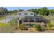 Aerial view of home's rear exterior, screened in pool, landscaping, and surrounding property at 4232 Spring Ln, Lakeland, FL 33811