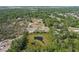 Aerial view showcases a beautiful home and acreage, complete with mature trees and an additional detached building at 4232 Spring Ln, Lakeland, FL 33811