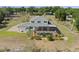 Aerial view of home's rear exterior, screened in pool, landscaping, and surrounding property at 4232 Spring Ln, Lakeland, FL 33811