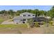 Aerial view of home's rear exterior, screened in pool, landscaping, and surrounding property at 4232 Spring Ln, Lakeland, FL 33811