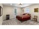 Bedroom with neutral carpet, queen bed with decorative bedding, and a door leading to the outside at 4232 Spring Ln, Lakeland, FL 33811