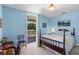 Cozy bedroom featuring a bed, desk, and access to the patio at 4232 Spring Ln, Lakeland, FL 33811