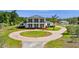 Beautiful view of the home, circular driveway, and detached garage surrounded by lush greenery and mature trees on the property at 4232 Spring Ln, Lakeland, FL 33811