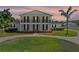 Stunning two-story home with a beautiful lawn and a circular driveway framed by classic columns and a balcony at 4232 Spring Ln, Lakeland, FL 33811