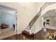 Beautiful foyer featuring hardwood floors, a staircase with wrought iron detailing, and views into adjoining rooms at 4232 Spring Ln, Lakeland, FL 33811