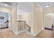Hallway featuring carpet floors and showcasing the stairs to the floor below at 4232 Spring Ln, Lakeland, FL 33811
