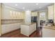 Bright kitchen with an island, granite countertops, white cabinetry, and hardwood floors at 4232 Spring Ln, Lakeland, FL 33811