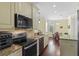 Modern kitchen featuring granite countertops, stainless steel appliances, and hardwood floors at 4232 Spring Ln, Lakeland, FL 33811