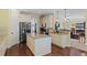 Bright kitchen featuring an island, stainless steel appliances, granite countertops, and hardwood floors at 4232 Spring Ln, Lakeland, FL 33811