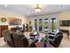 Cozy living room with access to outdoor pool area through glass doors and comfortable leather seating at 4232 Spring Ln, Lakeland, FL 33811