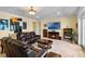 Comfortable living room with leather furniture, a fireplace, and a mounted TV at 4232 Spring Ln, Lakeland, FL 33811