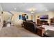 Spacious living room featuring plush leather seating, a fireplace, and warm lighting at 4232 Spring Ln, Lakeland, FL 33811