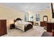 Spacious bedroom with carpet floors, crown molding, a chandelier, and abundant natural light at 4232 Spring Ln, Lakeland, FL 33811