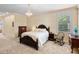 Comfortable main bedroom featuring a chandelier, carpet floors, and neutral colored walls at 4232 Spring Ln, Lakeland, FL 33811