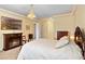 Spacious main bedroom with a fireplace, chandelier, crown molding, and neutral color palette at 4232 Spring Ln, Lakeland, FL 33811