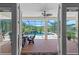 View through doors to a screened-in pool, patio furniture, and an outdoor waterfall feature at 4232 Spring Ln, Lakeland, FL 33811