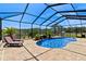 Sparkling pool surrounded by screen enclosure, brick pavers and lush landscaping at 4232 Spring Ln, Lakeland, FL 33811